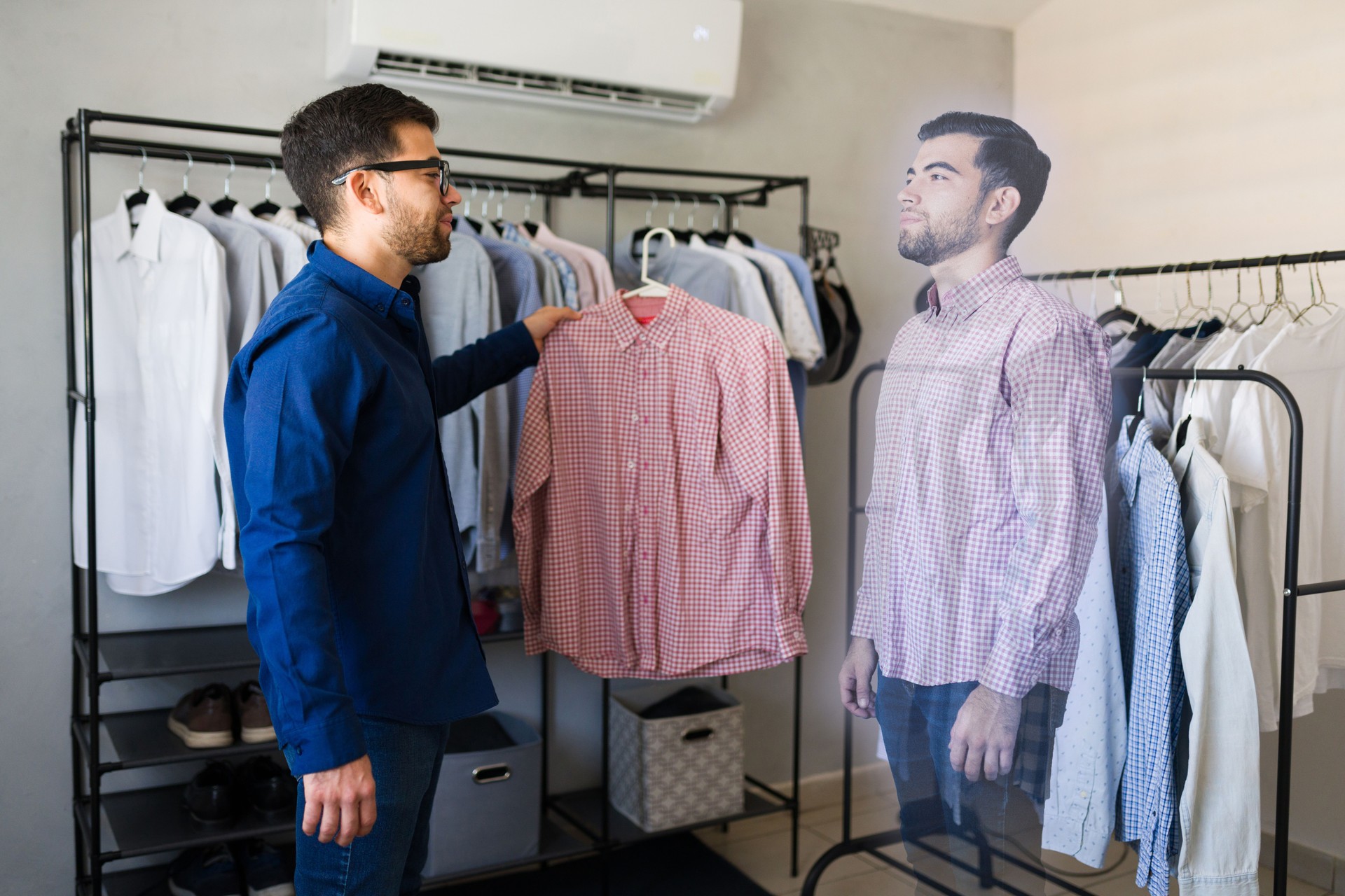 Man demonstrates augmented reality technology by virtually trying on a shirt